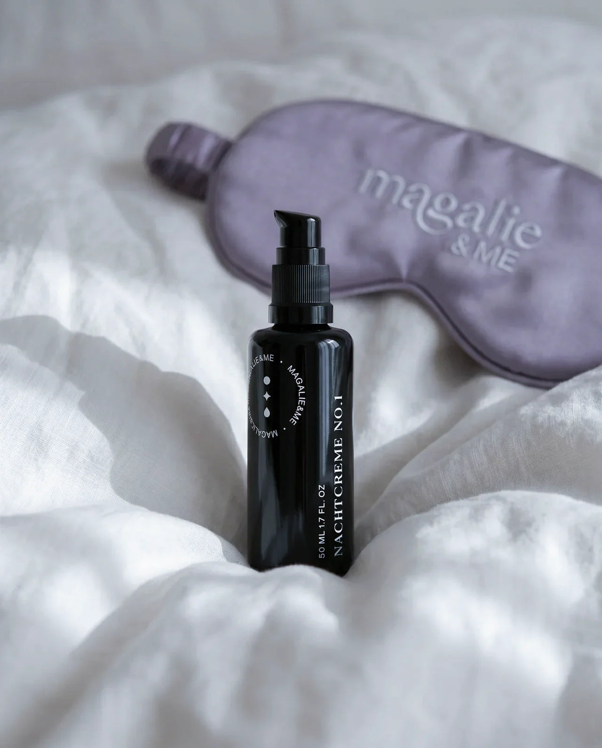Regenerating Day Cream No. 1 with a lavender silk sleep mask on white bedding
